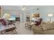 Open-concept living room features a stone fireplace, tile flooring, and comfortable seating arrangements at 28628 Twinbrook # Ln, Wesley Chapel, FL 33543