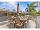 Inviting outdoor patio with dining set and umbrella, perfect for entertaining in the Florida sunshine at 28628 Twinbrook # Ln, Wesley Chapel, FL 33543