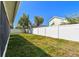 Fenced backyard view showing ample green space, perfect for outdoor activities at 3015 Azalea Blossom Dr, Plant City, FL 33567