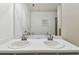 Bathroom features double sinks with tile flooring and large mirror at 3015 Azalea Blossom Dr, Plant City, FL 33567