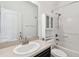 Bathroom featuring vanity with sink, commode, and shower with tiled surround at 3015 Azalea Blossom Dr, Plant City, FL 33567