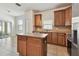 Kitchen with island, stainless appliances, and sliding door access to outdoor space at 3015 Azalea Blossom Dr, Plant City, FL 33567