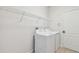 Laundry room with white washer, dryer, and wire shelving at 3015 Azalea Blossom Dr, Plant City, FL 33567
