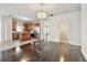 Open-concept living space with hardwood floors flows into a kitchen with stainless steel appliances at 3015 Azalea Blossom Dr, Plant City, FL 33567