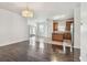 Open-concept living space with hardwood floors and seamless flow to the kitchen at 3015 Azalea Blossom Dr, Plant City, FL 33567