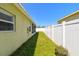 Green side yard with a lush lawn and a privacy fence at 3015 Azalea Blossom Dr, Plant City, FL 33567