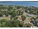 Stunning aerial view of a charming home nestled in a lush, green neighborhood near a beautiful bay at 315 Oakwood Blvd, Oldsmar, FL 34677