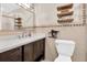 Bathroom with a modern sink and vanity, tiled walls, and decorative shelving at 315 Oakwood Blvd, Oldsmar, FL 34677
