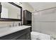Bathroom with a vanity, drawers, cabinet, mirror and a shower with glass doors with an installed toile at 315 Oakwood Blvd, Oldsmar, FL 34677