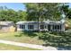 Charming single-story home boasts a lush green lawn, classic shutters, and a welcoming entrance at 315 Oakwood Blvd, Oldsmar, FL 34677