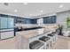 Bright kitchen with blue cabinets, granite countertops, stainless appliances, and a center island with bar seating at 315 Oakwood Blvd, Oldsmar, FL 34677