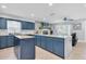 Spacious kitchen with granite counters, a center island, blue cabinets, a gas range, and an eat-in area at 315 Oakwood Blvd, Oldsmar, FL 34677