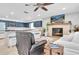 Open concept living area featuring a fireplace, modern furniture, coastal accents, and adjacent kitchen at 315 Oakwood Blvd, Oldsmar, FL 34677