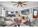Open living area with kitchen view, modern furniture, and a large television above an entertainment center at 315 Oakwood Blvd, Oldsmar, FL 34677