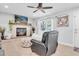 Bright living room featuring a fireplace, coastal decor, a white sofa, an accent chair, and tiled floors at 315 Oakwood Blvd, Oldsmar, FL 34677