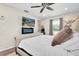 Comfortable bedroom with an electric fireplace, TV, and ceiling fan for added enjoyment at 315 Oakwood Blvd, Oldsmar, FL 34677