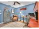 Office featuring blue walls, laminate floors, built-in shelves, and a leather chair at 315 Oakwood Blvd, Oldsmar, FL 34677