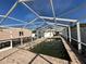 Enclosed pool area with a weathered brick surround, with the pool's structure under a full screen enclosure at 4031 Bay Ne St, St Petersburg, FL 33703