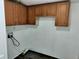 Utility area with upper cabinets and hook ups for washer and dryer at 4102 Fox Ridge Blvd, Wesley Chapel, FL 33543