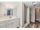 Bathroom features new vanity, updated shower with bench, and wood-look flooring at 4301 Coronet Rd, Plant City, FL 33566