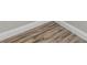 Close up of new wood-look flooring with white trim at 4301 Coronet Rd, Plant City, FL 33566
