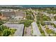Expansive aerial view showcasing the property's location with mature trees and city views at 500 Glennes Ln # 205, Dunedin, FL 34698