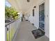Long exterior view of the entrance to the apartments with secured doors and an airy patio at 500 Glennes Ln # 205, Dunedin, FL 34698