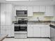 Efficient kitchen boasts stainless steel appliances, granite countertops, and white cabinets at 500 Glennes Ln # 205, Dunedin, FL 34698