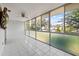 The sunroom offers ample space with tile flooring, wall to wall windows, and views to the outside at 500 Glennes Ln # 205, Dunedin, FL 34698