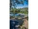Backyard scene with a white picket fence, lush landscaping, and water views at 5153 Bay Blvd, Port Richey, FL 34668