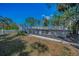 Backyard featuring a raised bar with stools and deck overlooking nature, great for outdoor entertaining and relaxing at 5153 Bay Blvd, Port Richey, FL 34668