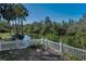 Scenic backyard with white picket fence and partial water view, providing a tranquil and private outdoor space at 5153 Bay Blvd, Port Richey, FL 34668