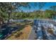 Backyard with a slide, play area, white fence, mature trees, and water view at 5153 Bay Blvd, Port Richey, FL 34668