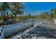 Backyard featuring a pool and playset, offering an outdoor space for relaxation and entertainment at 5153 Bay Blvd, Port Richey, FL 34668
