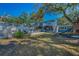 Spacious backyard featuring a large deck, bar area, and playset at 5153 Bay Blvd, Port Richey, FL 34668