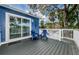 This charming balcony features comfortable blue Adirondack chairs perfect for relaxing outdoors at 5153 Bay Blvd, Port Richey, FL 34668