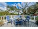 Outdoor seating area on balcony provides a relaxing view of the surrounding landscape and water at 5153 Bay Blvd, Port Richey, FL 34668