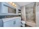 Well-lit bathroom with tub, shower, and storage shelves for a comfortable and organized space at 5153 Bay Blvd, Port Richey, FL 34668