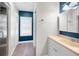Bright bathroom with a window, modern vanity, and shower with glass doors at 5153 Bay Blvd, Port Richey, FL 34668