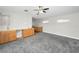 Spacious bonus room featuring plush carpeting, ceiling fan, and built in cabinets at 5153 Bay Blvd, Port Richey, FL 34668