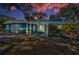 Charming blue two-story home featuring a pergola-covered entrance and well-maintained front yard at 5153 Bay Blvd, Port Richey, FL 34668