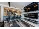 Chic living space features a modern fireplace, large TV, and bar seating overlooking a sleek kitchen for entertaining at 5153 Bay Blvd, Port Richey, FL 34668