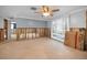 Bright living room under renovation with natural light from large windows and a ceiling fan at 5153 Bay Blvd, Port Richey, FL 34668