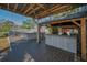 Outdoor bar area with wooden beams, decking, and stools providing a perfect space for entertaining and relaxation at 5153 Bay Blvd, Port Richey, FL 34668