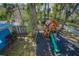 Aerial view of the outdoor playhouse, play structure, shed, and water view at 5153 Bay Blvd, Port Richey, FL 34668