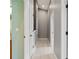 Hallway with neutral paint, light hardwood flooring, and access to rooms at 569 52Nd N Ave, St Petersburg, FL 33703