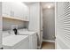 Bright laundry room with white cabinets and a modern washer and dryer at 569 52Nd N Ave, St Petersburg, FL 33703