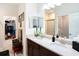 Bathroom featuring double sink vanity, large mirror and walk in closet at 5714 Colony Glen Rd, Lithia, FL 33547