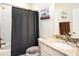Bathroom featuring granite counters, tub and shower combo, and grey accent towels at 5714 Colony Glen Rd, Lithia, FL 33547