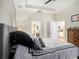 Bright bedroom featuring tray ceiling and doorways to en suite bathroom and kitchen at 5714 Colony Glen Rd, Lithia, FL 33547